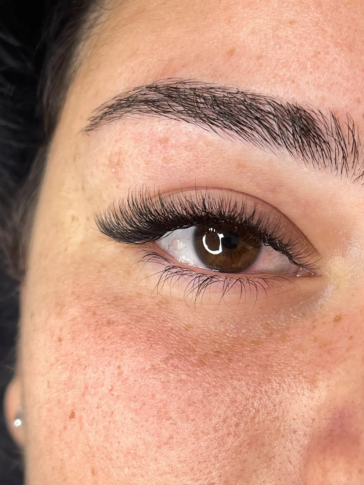 Close-up of full, natural lash extensions by Beauty Studio GLAM